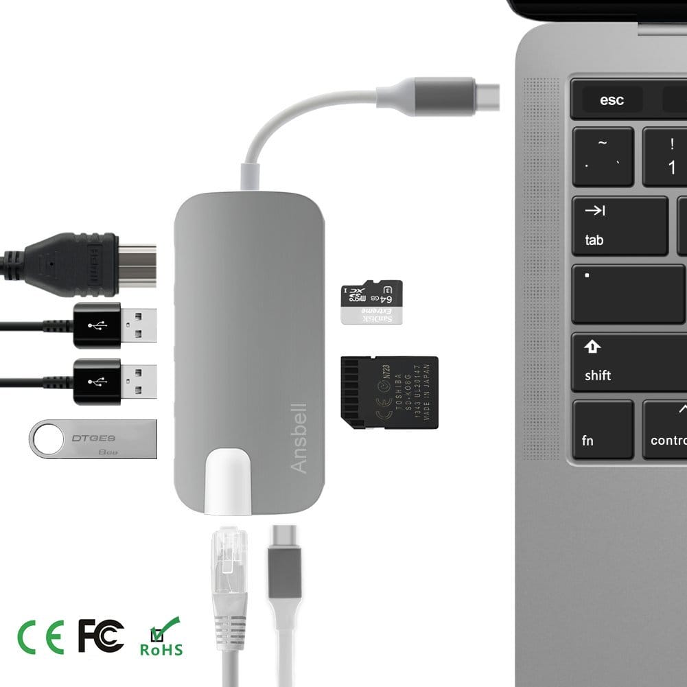 Image shows the adapter next to a laptop.
