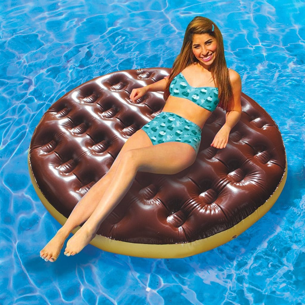 Image shows a woman floating on the pool float in a pool.