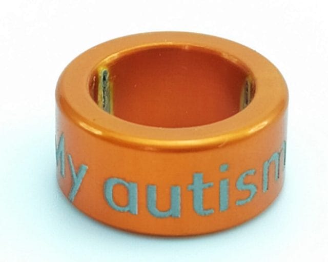 Image shows an Orange NOTCH with the wording 'My autism is unique'
