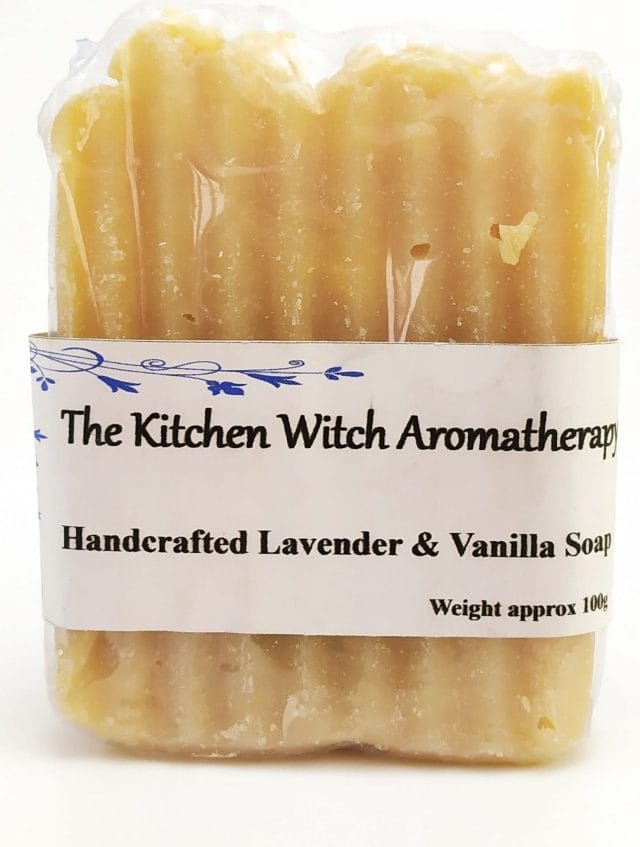 Image shows a bar of soap wrapped in plastic film. There's a label on the front which says, The Kitchen Witch Aromatherapy (next line) Handcrafted Lavender and Vanilla Soap (next line) Weight approx 100G.