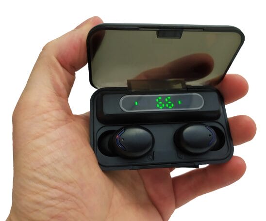 Image shows the earphones inside the charging box. I'm holding the case with my left hand.