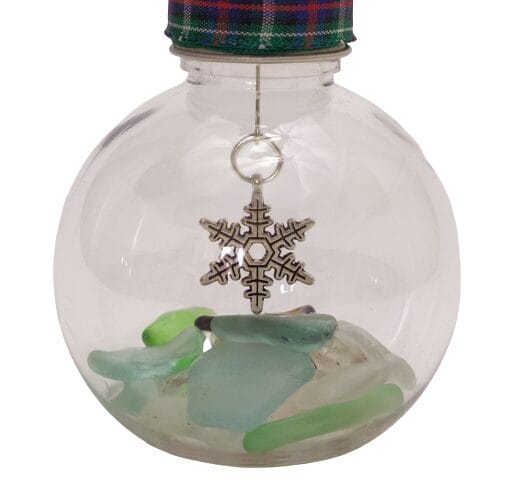 Image shows a close up view of the snowflake charm and the sea glass.