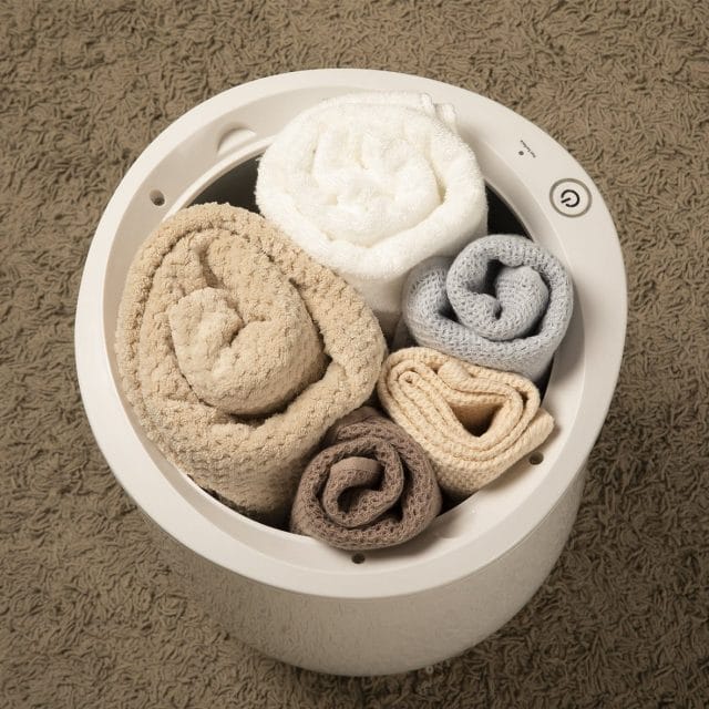 Image shows the towel warmer with 5 towels inside.