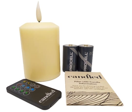 Images shows the Candles supplied contents, this includes the candle, batteries, remote control and the user guide.