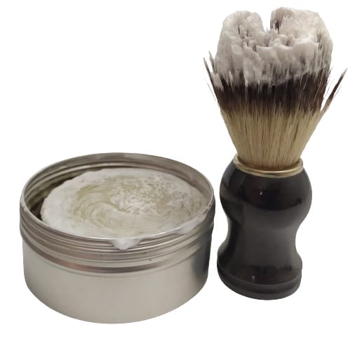 Image shows a shaving brush freshly dipped in the shaving soap.