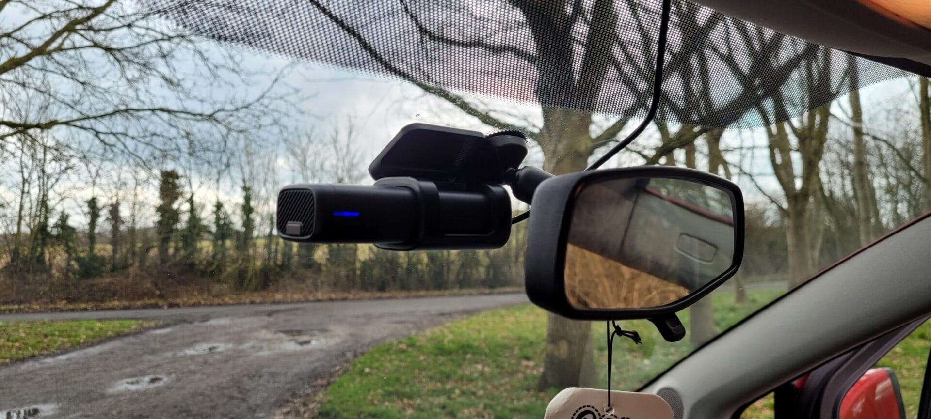 Image shows the dashcam installed behind the mirror.