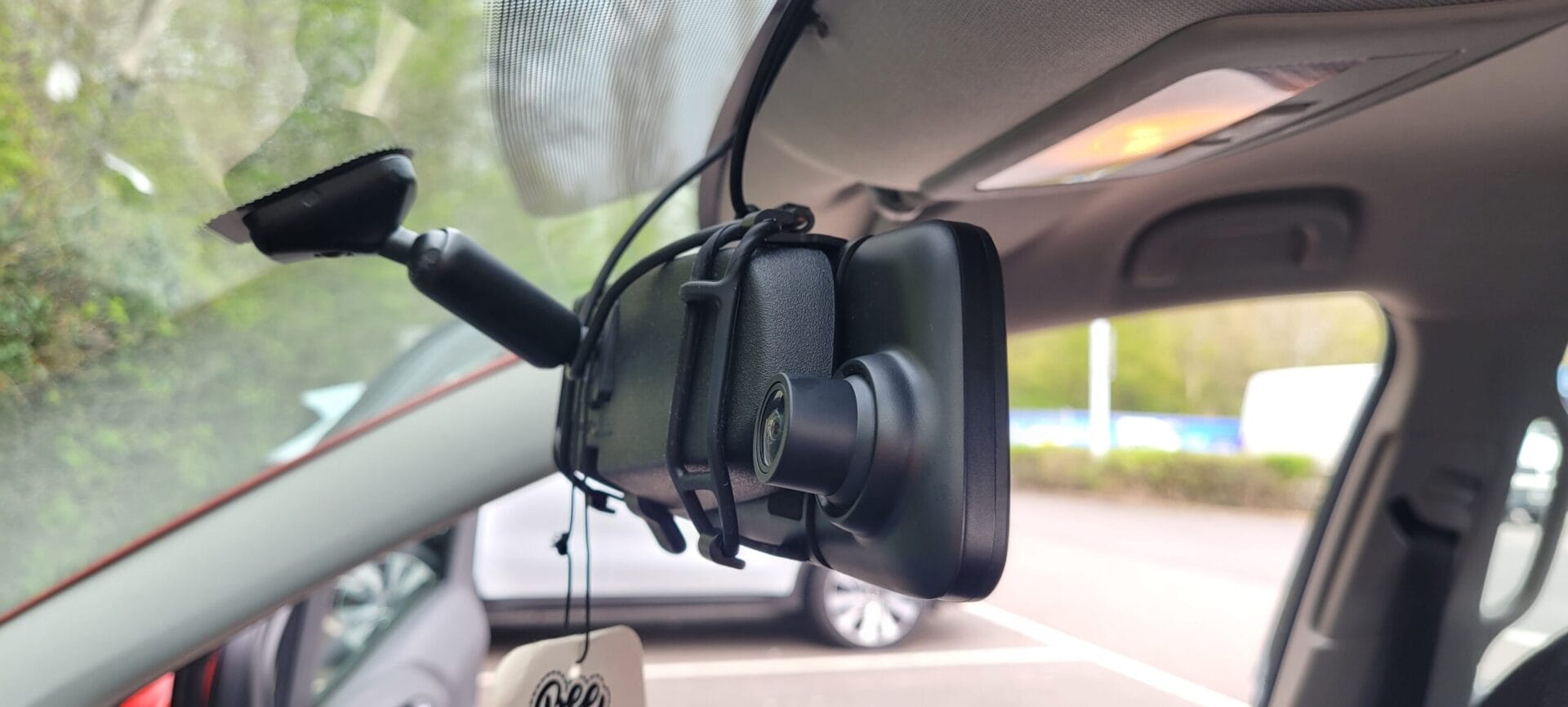 Image shows the Road Angel Halo View strapped around my car's centre mirror.