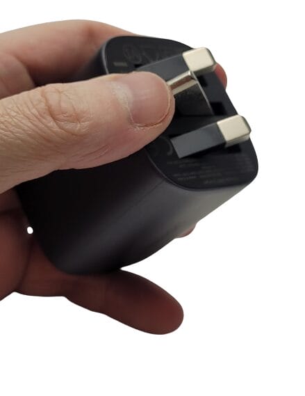 Image shows me holding the plug in my left hand, I'm folding the pins to the plug.
