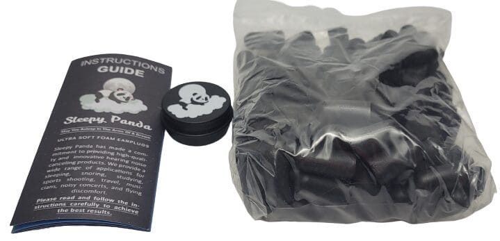Image shows the included contents, there's the instruction guide, carry tin, and earplugs in a plastic bag.