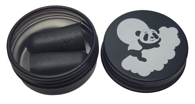 Image shows the carry tin, the screw lid is to the righthand side, whilst the tin is holding a pair of earplugs.