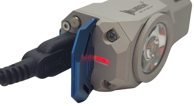 Wuben Knight X0 Torch Image shows the torch being charged. A red light is on to indicate charging.