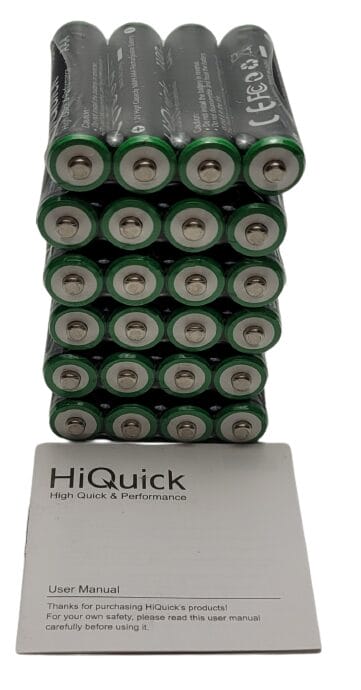 Image shows a stack of batteries and the user guide in front.