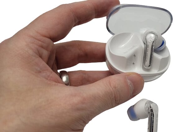 Image shows me opening up the case with one earbud removed to show the design of the placement. 