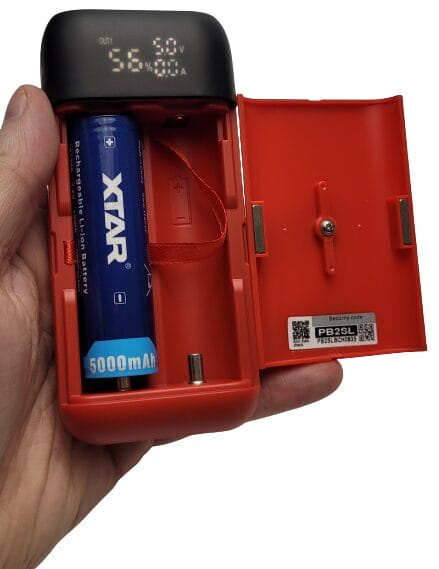 Image shows the battery charger with a 21700 battery cell.