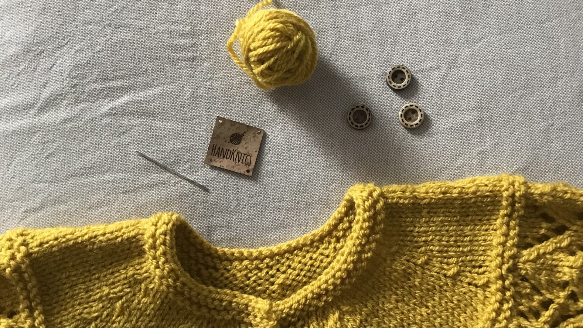 Label-and-neckline-of-cardigan-yellow