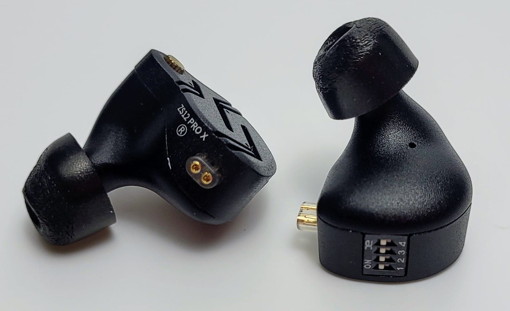 Image shows a pair of IEM's and the associated tuning switches.