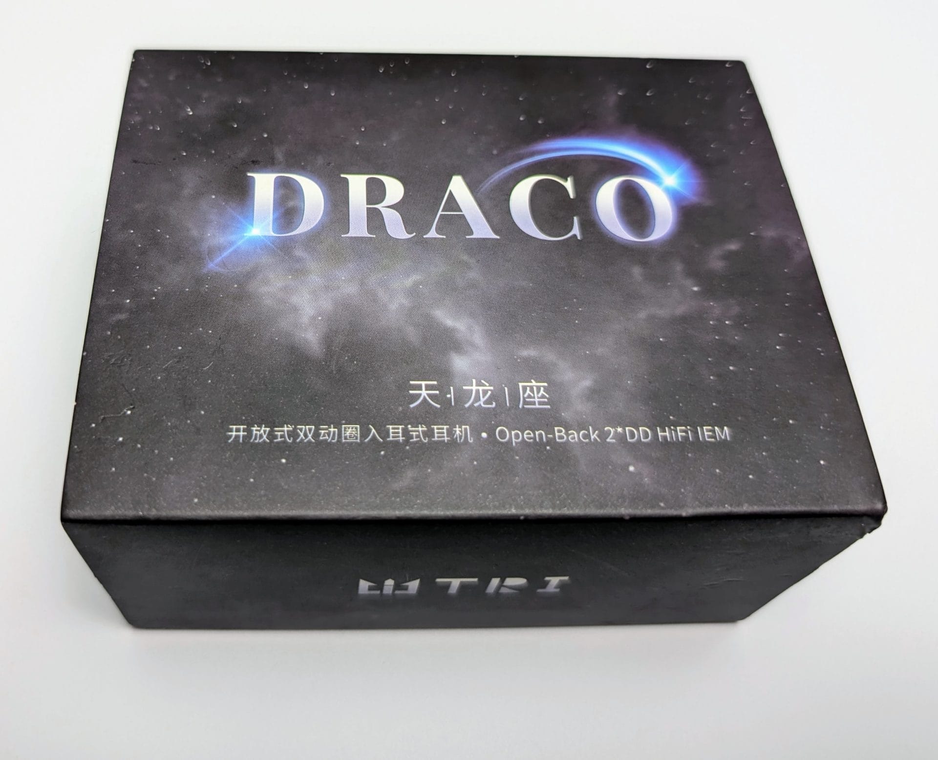 Image shows the outer packaging for the TRI Draco Open-Back 2DD IEMs