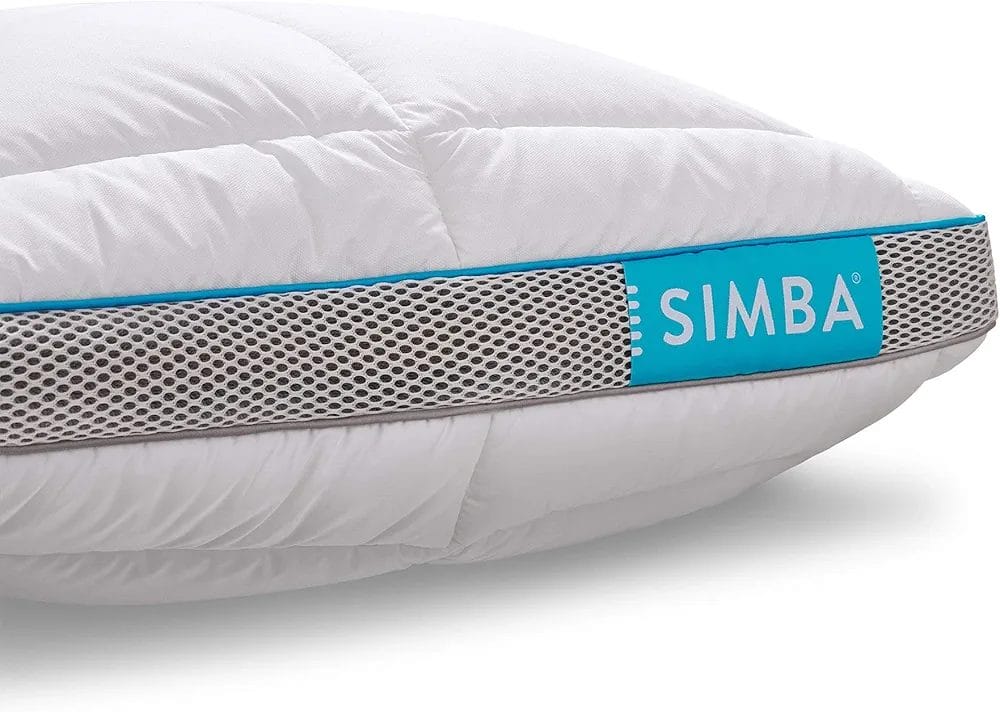 A close-up image of a Simba Hybrid Pillow, featuring a white, quilted upper surface and a breathable, mesh side panel with a blue accent. The Simba logo is prominently displayed in white text on the blue section of the mesh side. The pillow is designed for comfort and support, with a modern and sleek appearance.