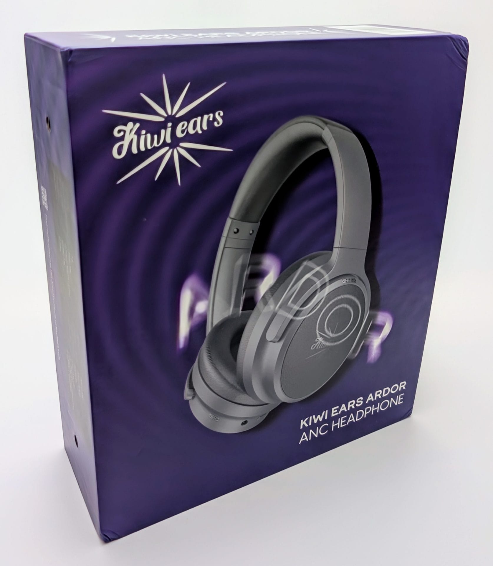 Kiwi Ears Ardor A box for the Kiwi Ears Ardor ANC headphone, featuring a sleek gray over-ear headphone design on a purple background with the brand name "Kiwi Ears" and product name "Kiwi Ears Ardor ANC Headphone" printed on it.