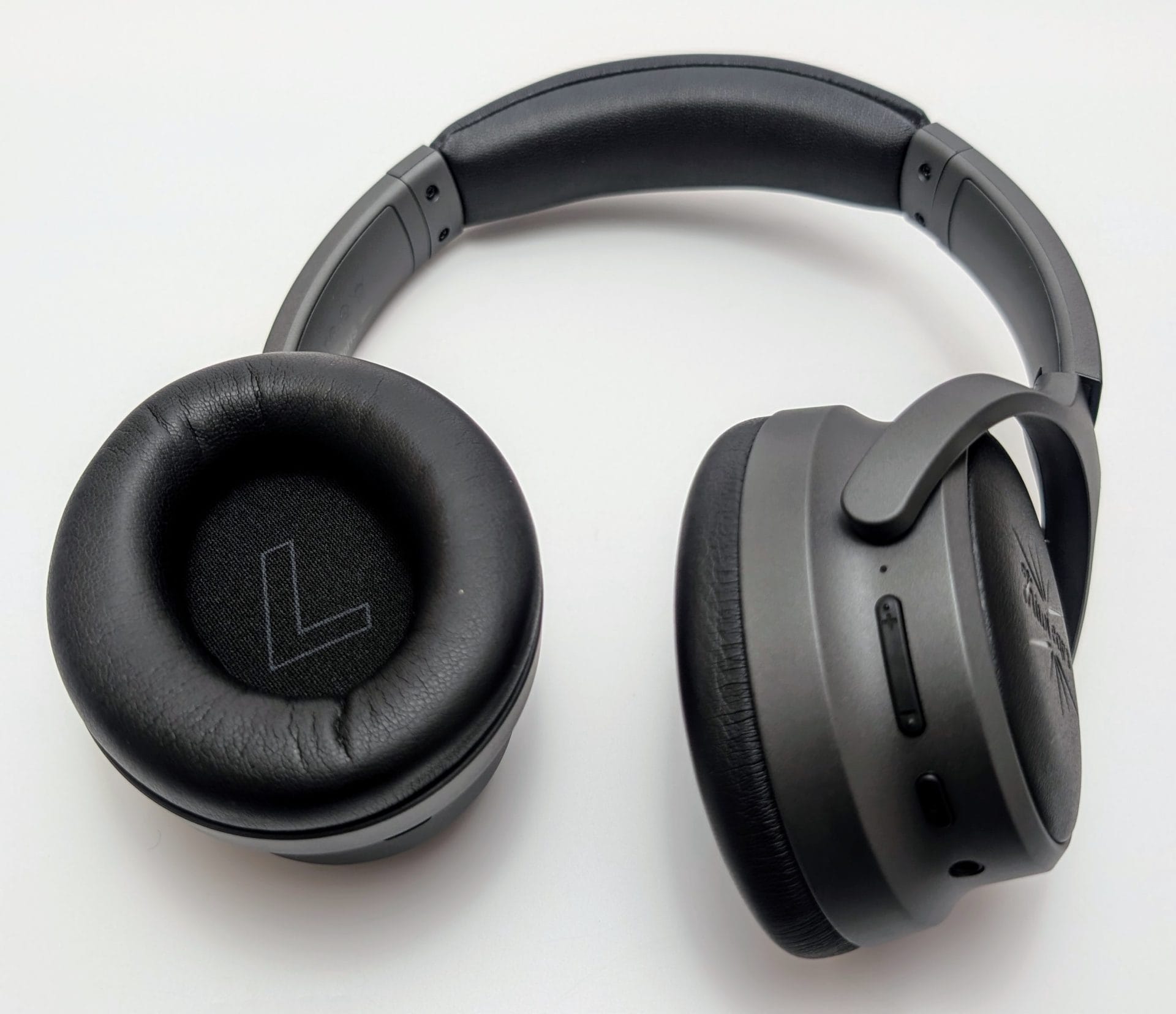 Kiwi Ears Ardor A pair of Kiwi Ears Ardor headphones viewed from the top, showing a black and gray over-ear design with a padded headband. The left ear cup has an "L" marking, and the right ear cup features control buttons and the Kiwi Ears logo.