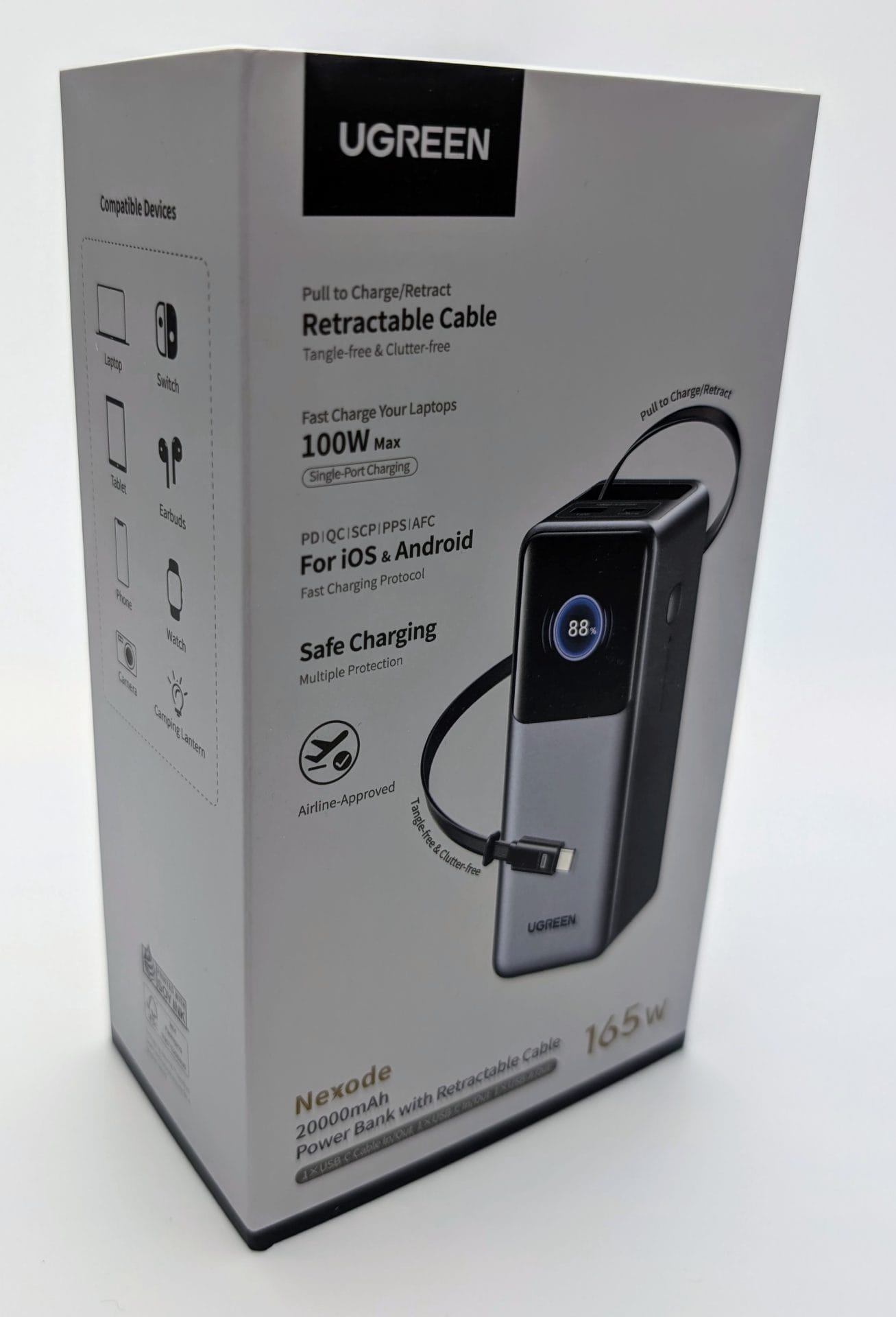UGREEN Nexode Power Bank 20000mAh 165W with Retractable USB-C Cable UGREEN Nexode 20000mAh 165W Power Bank with Retractable USB-C Cable packaging. The box features a sleek black and silver power bank with a retractable cable and a digital display showing 88% charge. The packaging highlights 100W max single-port charging, PD/QC/iQ/SCP/UFCS protocols for iOS and Android, safe charging with multiple protections, and airline approval. Compatible devices include laptops, tablets, phones, Switch, earbuds, watches, cameras, and camping lanterns. The box also mentions a tangle-free and clutter-free design.