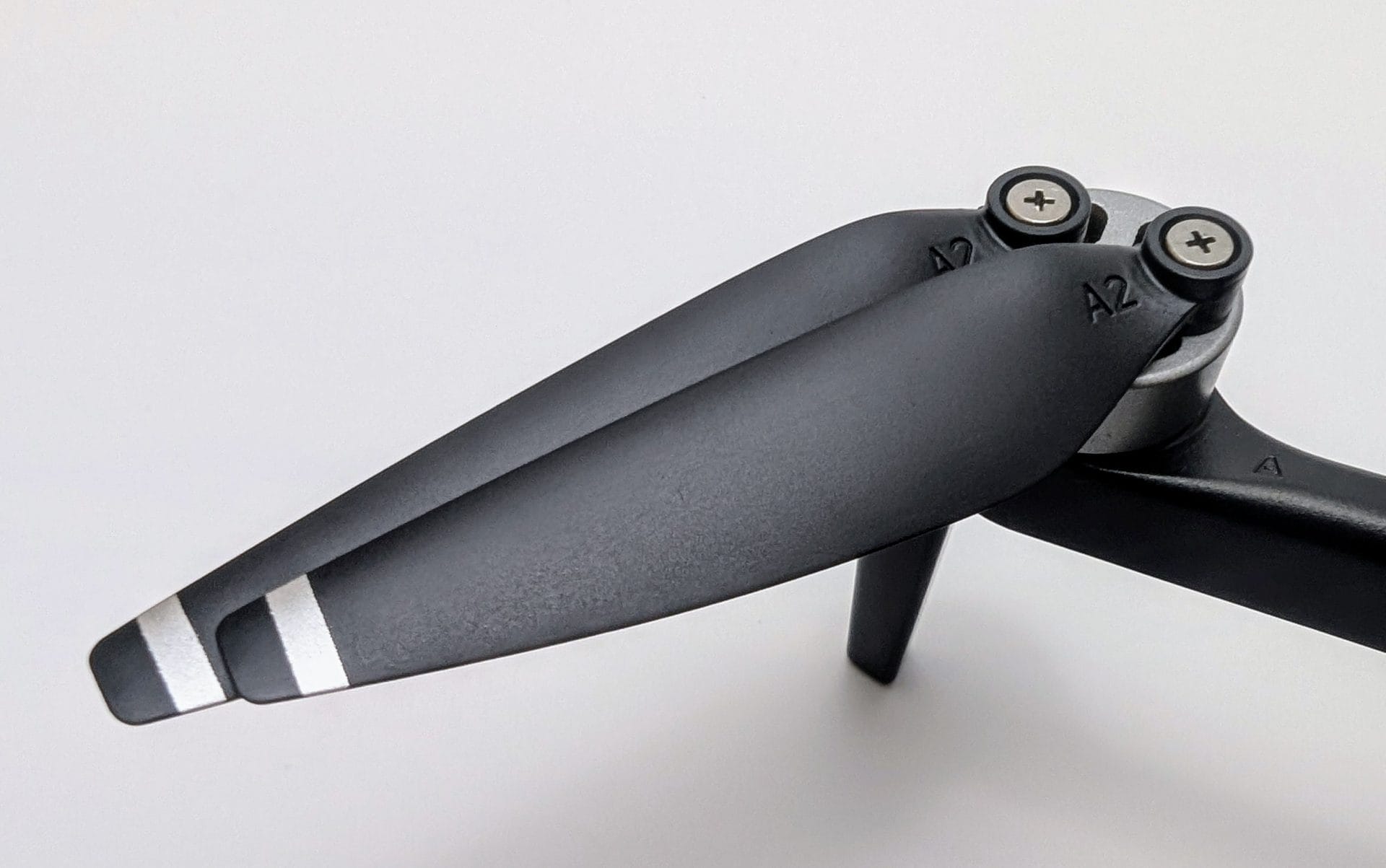 A close-up view of the black propellers attached to the Ruko U11MINI 4K Drone, featuring a metallic hub with screws and labels marked "A2" on the blades, set against a white background.