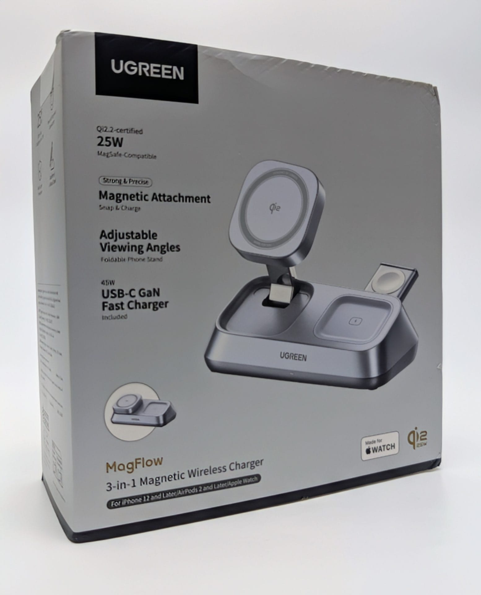 UGREEN MagFlow 3-in-1 Magnetic Wireless Desktop Charger UGREEN MagFlow 3-in-1 Magnetic Wireless Charger retail box. The charger is a grey desktop stand designed to simultaneously charge an iPhone 12 or later (via a foldable, adjustable MagSafe-compatible 25W Qi2 charging pad), AirPods 2 or later, and an Apple Watch. Key features highlighted on the box include Qi2-certified, 25W output, strong magnetic attachment, adjustable viewing angles, and an included 45W USB-C GaN Fast Charger.