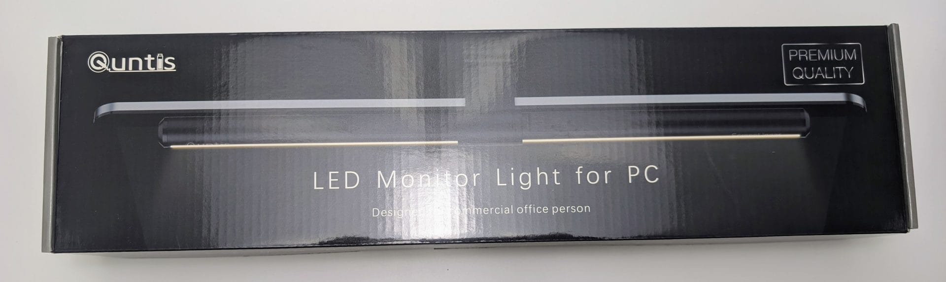 Quntis LED Monitor Light Bar in black premium packaging box, showing the slim clip-on desk lamp designed for computer monitors with eye-care features and no-glare illumination.